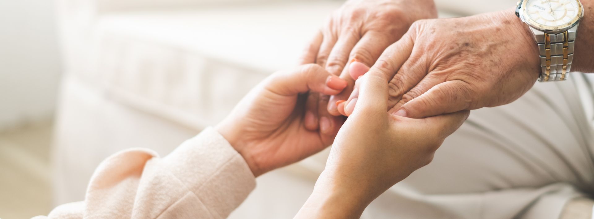 woman hand holding senior hand with love and care